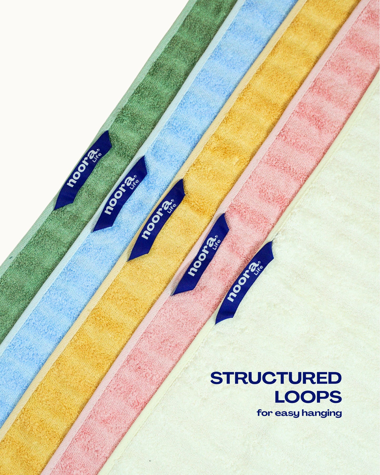 Colorful towel loop tags with 'Noora' branding and text 'Structured Loops for easy hanging' on a white background.