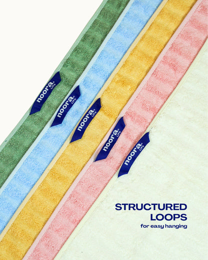 Colorful towel loop tags with 'Noora' branding and text 'Structured Loops for easy hanging' on a white background.
